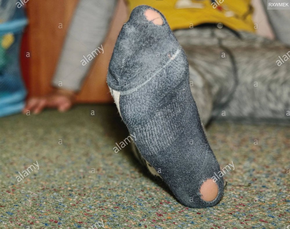 worn-socks-with-a-hole-and-heel-sticking-out-old-worn-clothes-RXWMEK.jpg