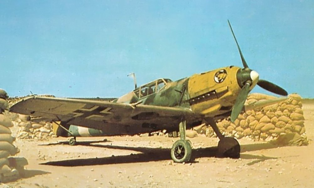 Messerschmitt-Bf-109E7Trop-I.JG27-in-its-blast-pen-Gazala-North-Africa-1941-01.thumb.jpg.797d682cd371664adc6b5a73da3cf4d8.jpg